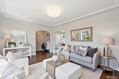 a living room with furniture a lamp and a chandelier