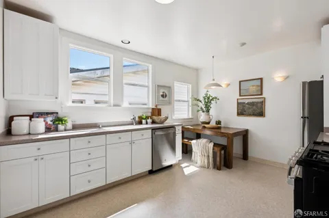 a kitchen with a sink stove and cabinets