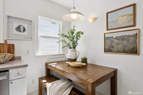 a dining room with table chairs and wooden floor