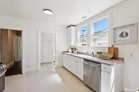 a kitchen with a sink stove and cabinets