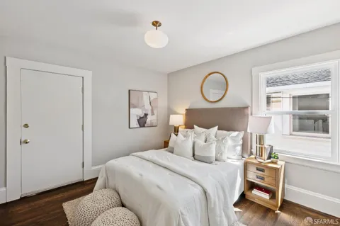 a bedroom with bed and wooden floor