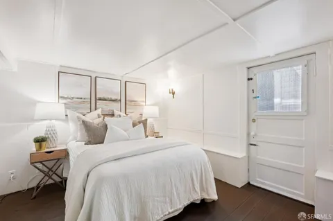 a bedroom with a bed a couch and dresser