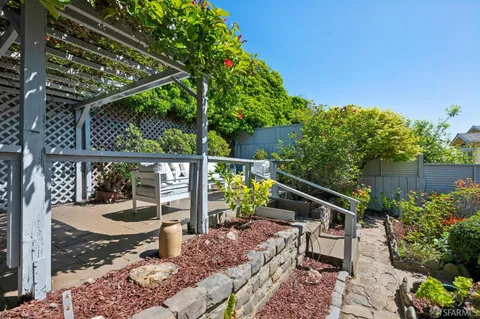 a view of a patio with table and chairs and potted plants