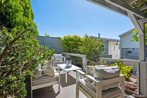 a view of a patio with couches chairs and potted plants