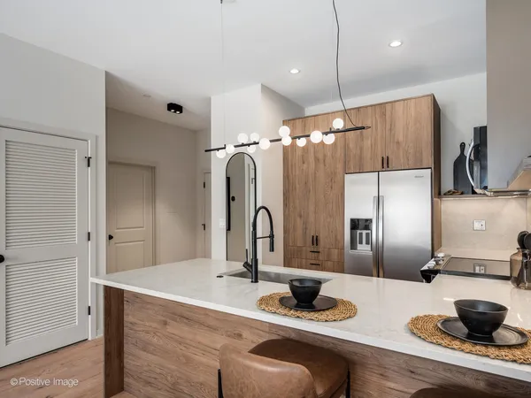 a kitchen with a refrigerator and cabinets