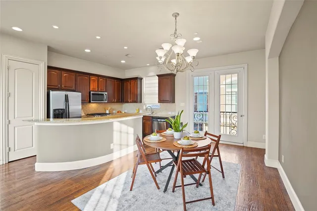 a view of a dining room with furniture wooden floor and chandelier
