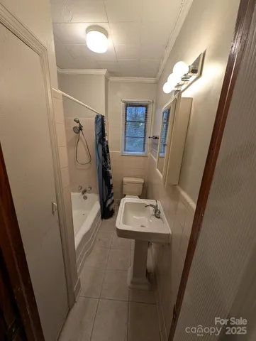 a bathroom with double vanity sink and shower