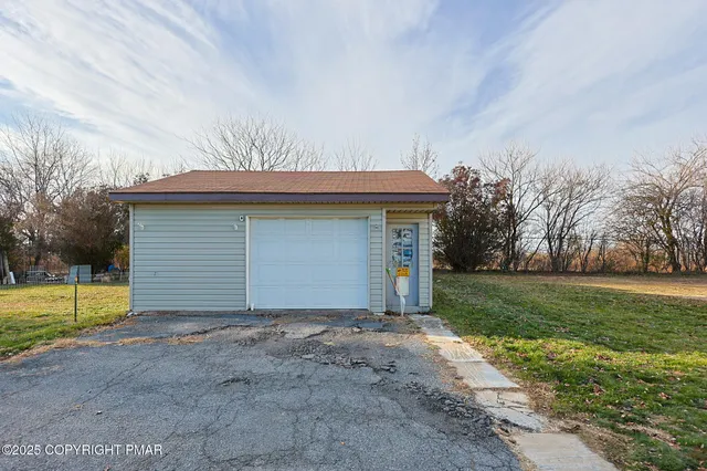 a view of a house with a yard and garage