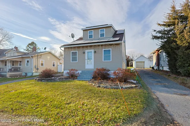 a front view of house with yard and outdoor seating