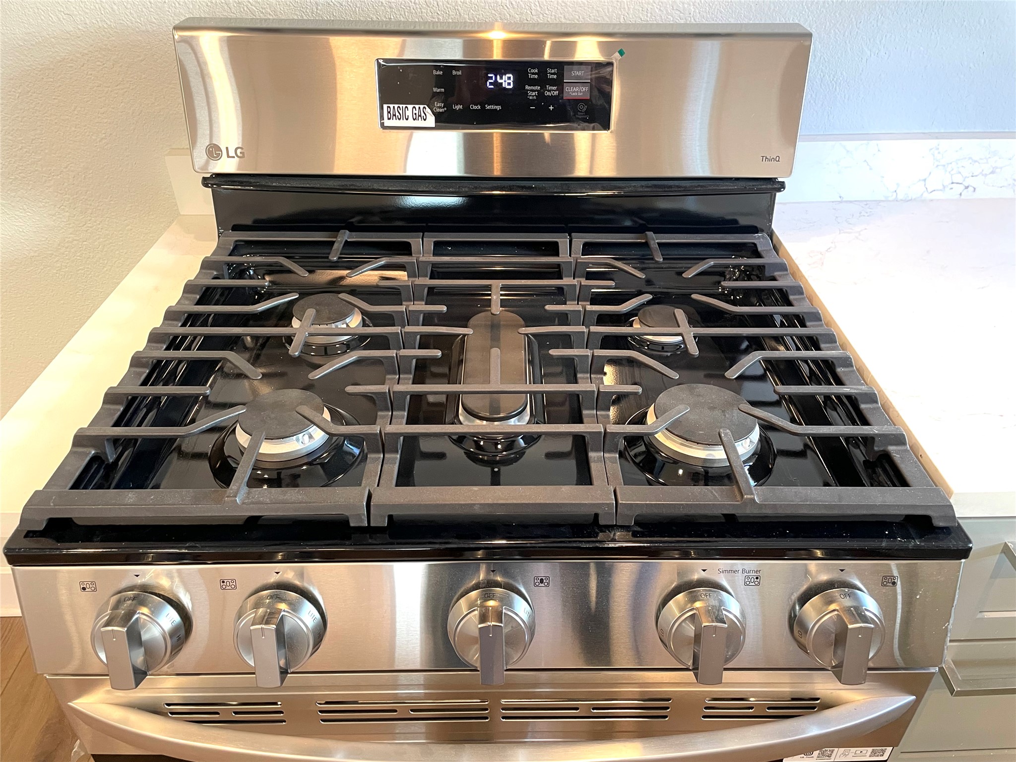 807 East Riverside Drive, Unit A Austin, TX 78704 - Photo 12 of 29 Kitchen view of stainless steel gas stove, a textured wall, and light stone counters