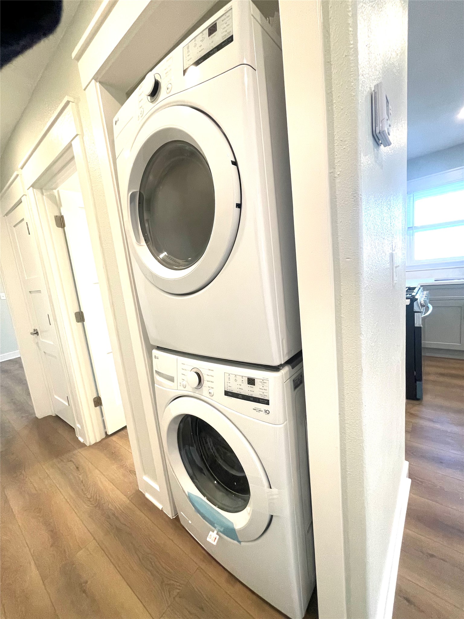 807 East Riverside Drive, Unit A Austin, TX 78704 - Photo 13 of 29 Laundry area with dark wood-type flooring and stacked washer and dryer