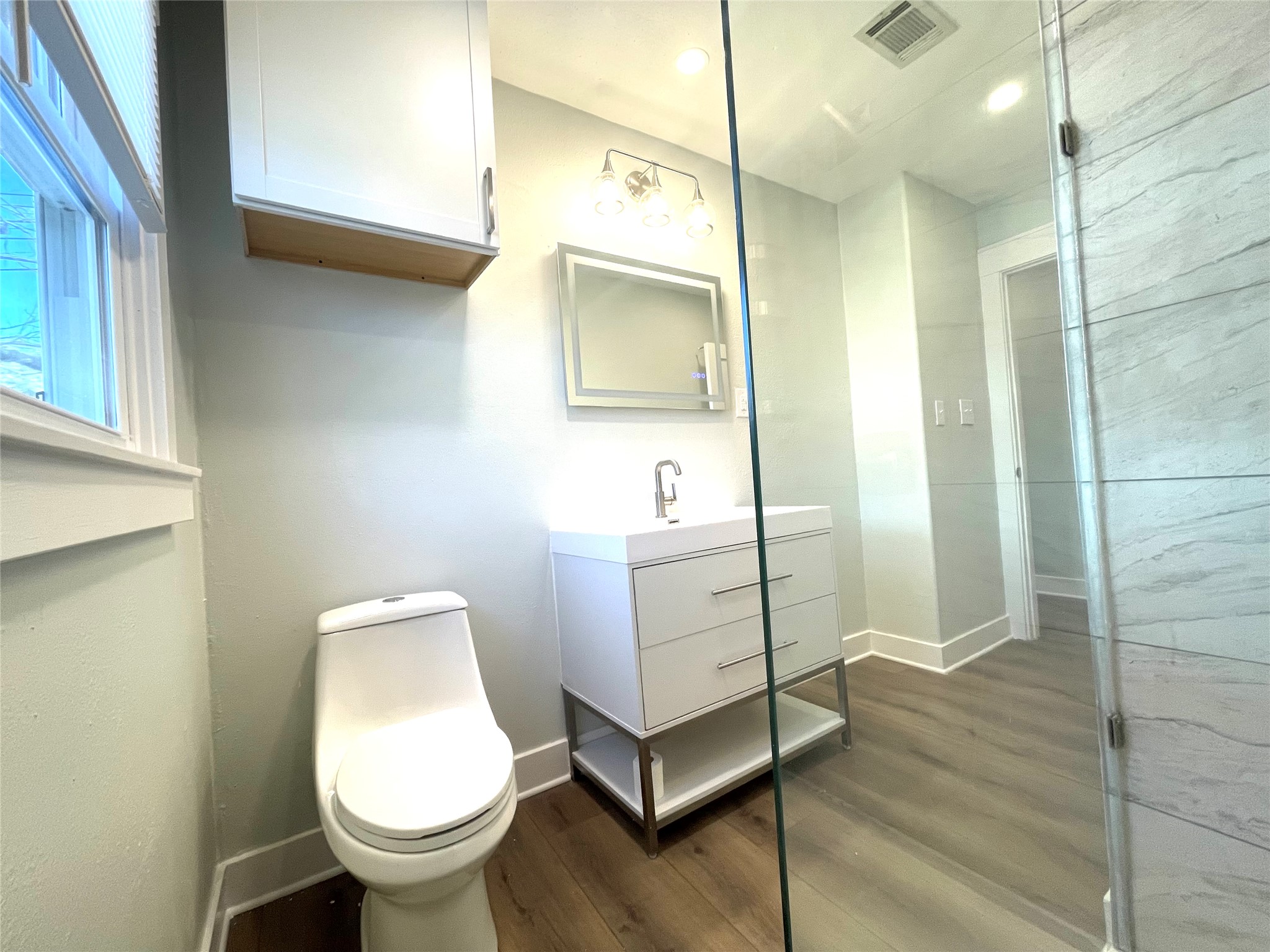 807 East Riverside Drive, Unit A Austin, TX 78704 - Photo 15 of 29 Bathroom featuring vanity, dark wood-style flooring, and recessed lighting