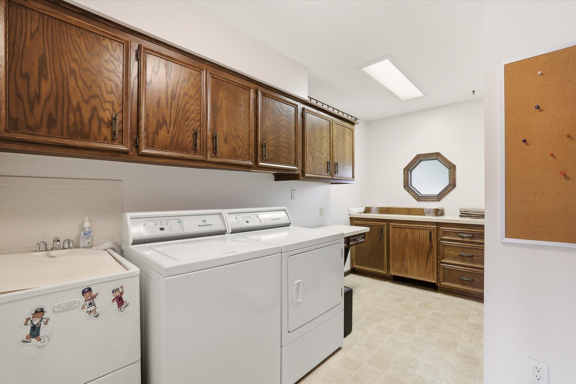 4100 South 119th Street Greenfield, WI 53228 - Photo 15 of 31 Laundry room with clost and planning desk and folding area.