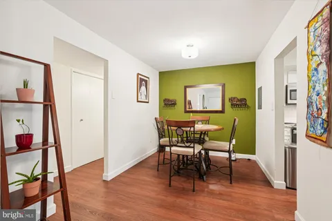 a view of a dining room with furniture and wooden floor