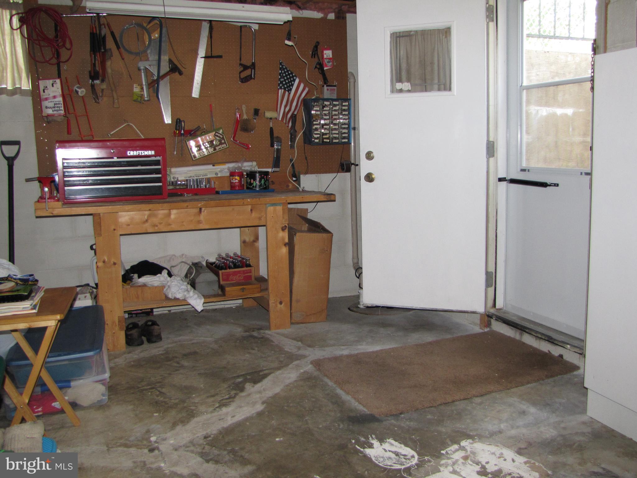 7767 Notley Road Pasadena, MD 21122 - Photo 30 of 31 Part of unfinished basement with workbench