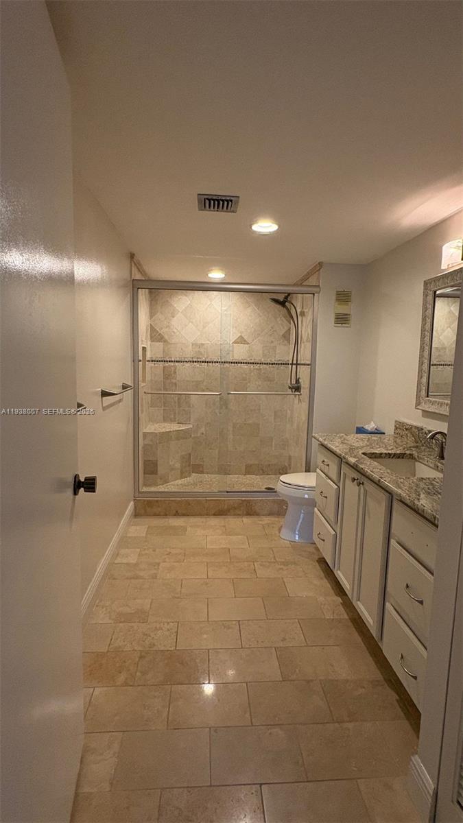 6300 Northwest 2nd Avenue, Unit 403 Boca Raton, FL 33487 - Photo 12 of 20 a bathroom with a sink a toilet and shower