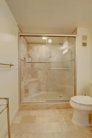 a bathroom with a shower and a toilet