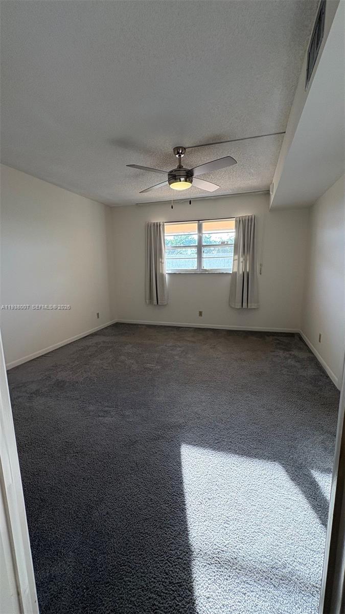 6300 Northwest 2nd Avenue, Unit 403 Boca Raton, FL 33487 - Photo 15 of 20 an empty room with windows and chandelier