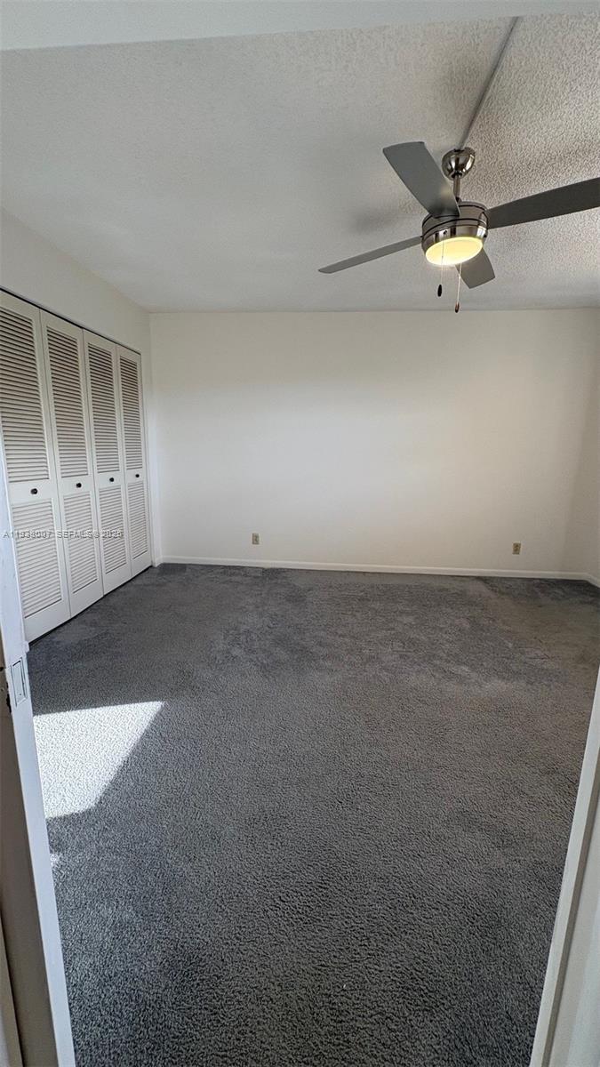 6300 Northwest 2nd Avenue, Unit 403 Boca Raton, FL 33487 - Photo 16 of 20 an empty room with a ceiling fan and window