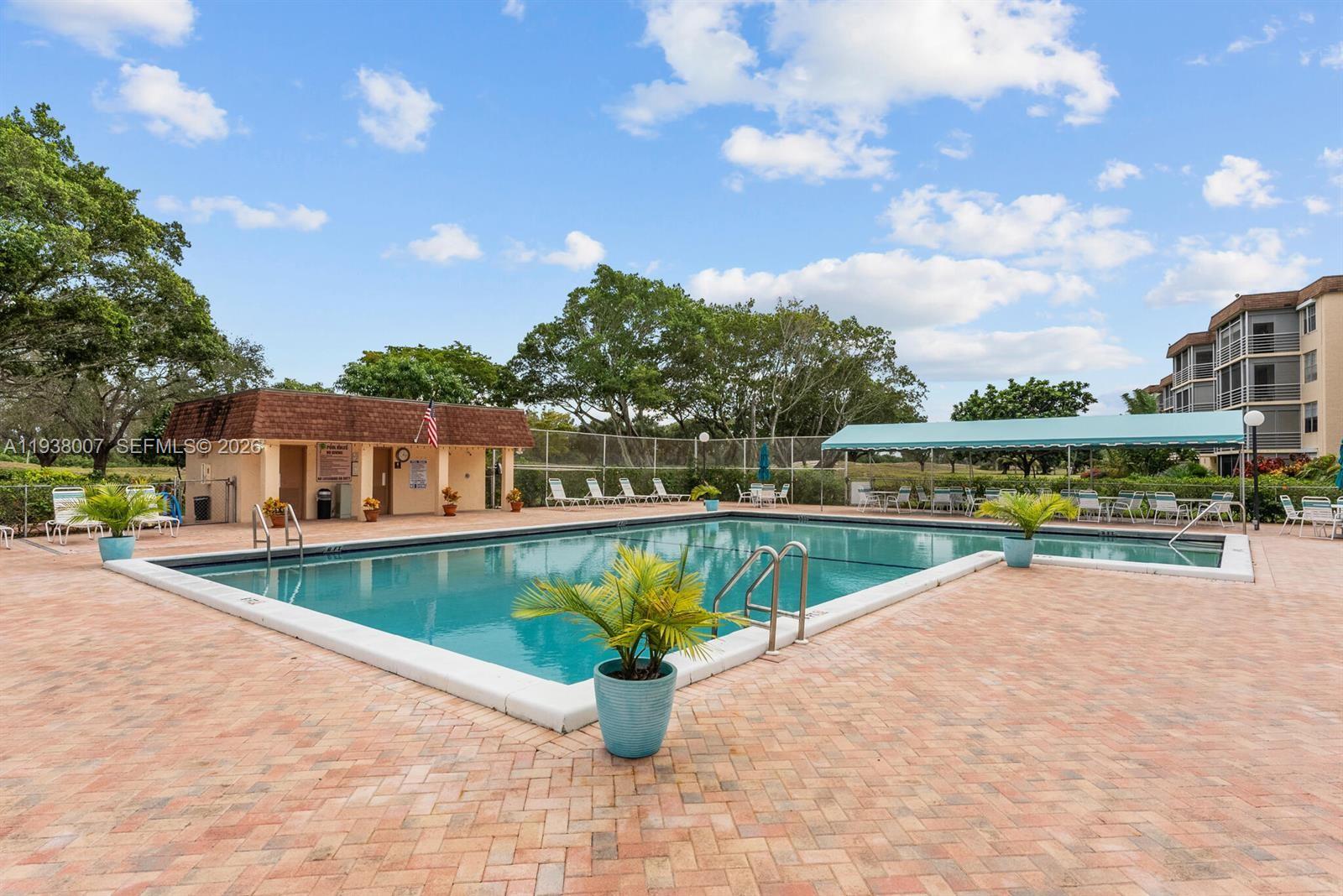 6300 Northwest 2nd Avenue, Unit 403 Boca Raton, FL 33487 - Photo 18 of 20 a view of a swimming pool with a patio and a garden