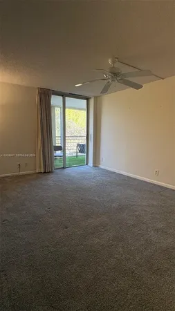 a view of a livingroom with an empty space and a window