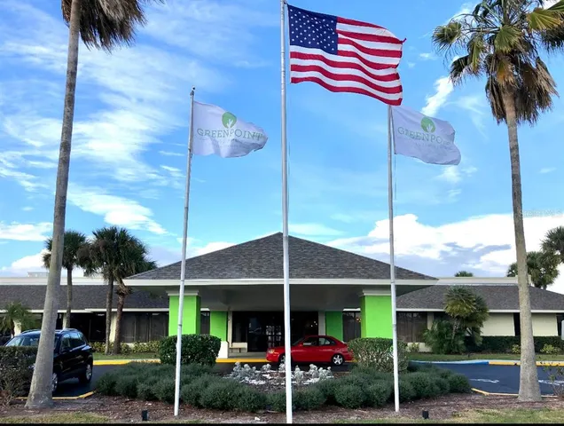 a view of a house with a yard and sitting area