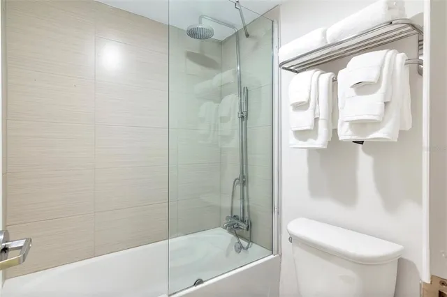 a bathroom with a shower and a toilet