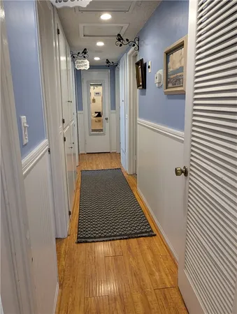 a view of a hallway with wooden floor