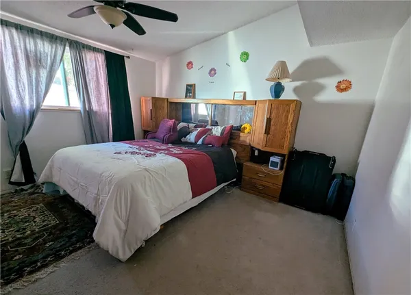 a bed sitting in a room next to a window