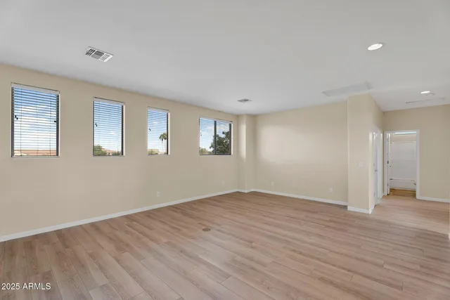 a bathroom with a granite countertop sink a light fixture and a mirror