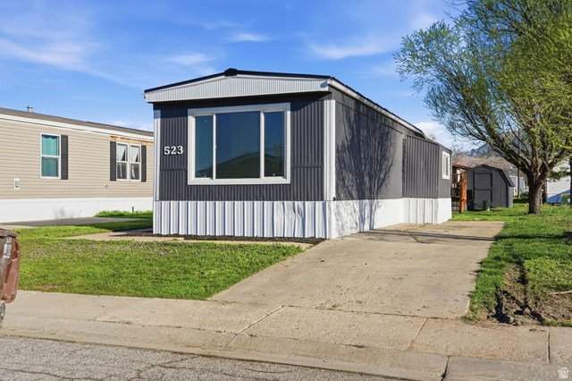 2491 Highway 89, Unit 523 Pleasant View, UT 84404 - Photo 3 of 31 Manufactured / mobile home featuring a front lawn and a storage unit