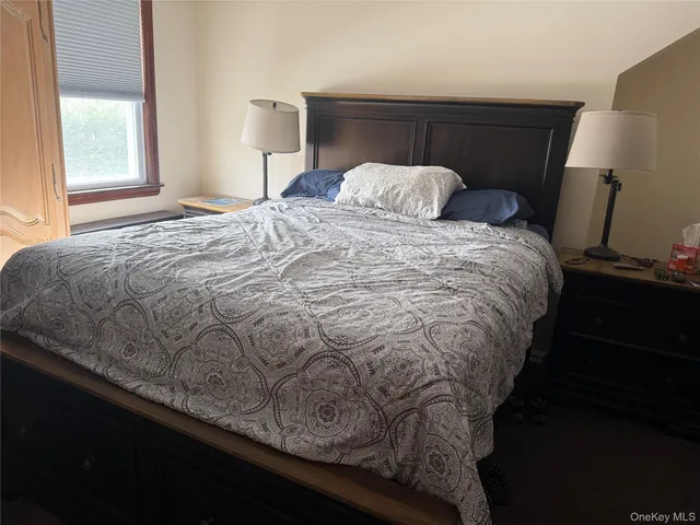 a bedroom with a bed and window