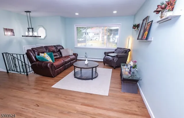 a living room with furniture and a wooden floor
