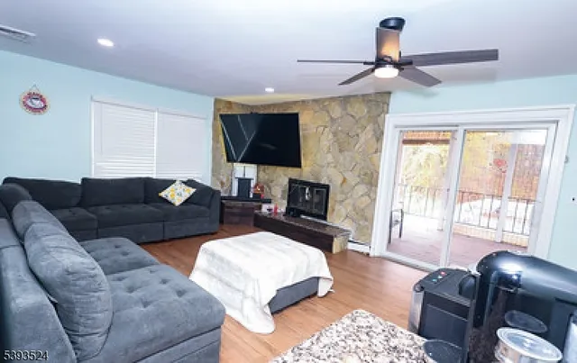 a living room with furniture a flat screen tv and a window