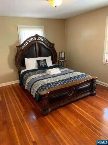 a bedroom with a bed and a mirror