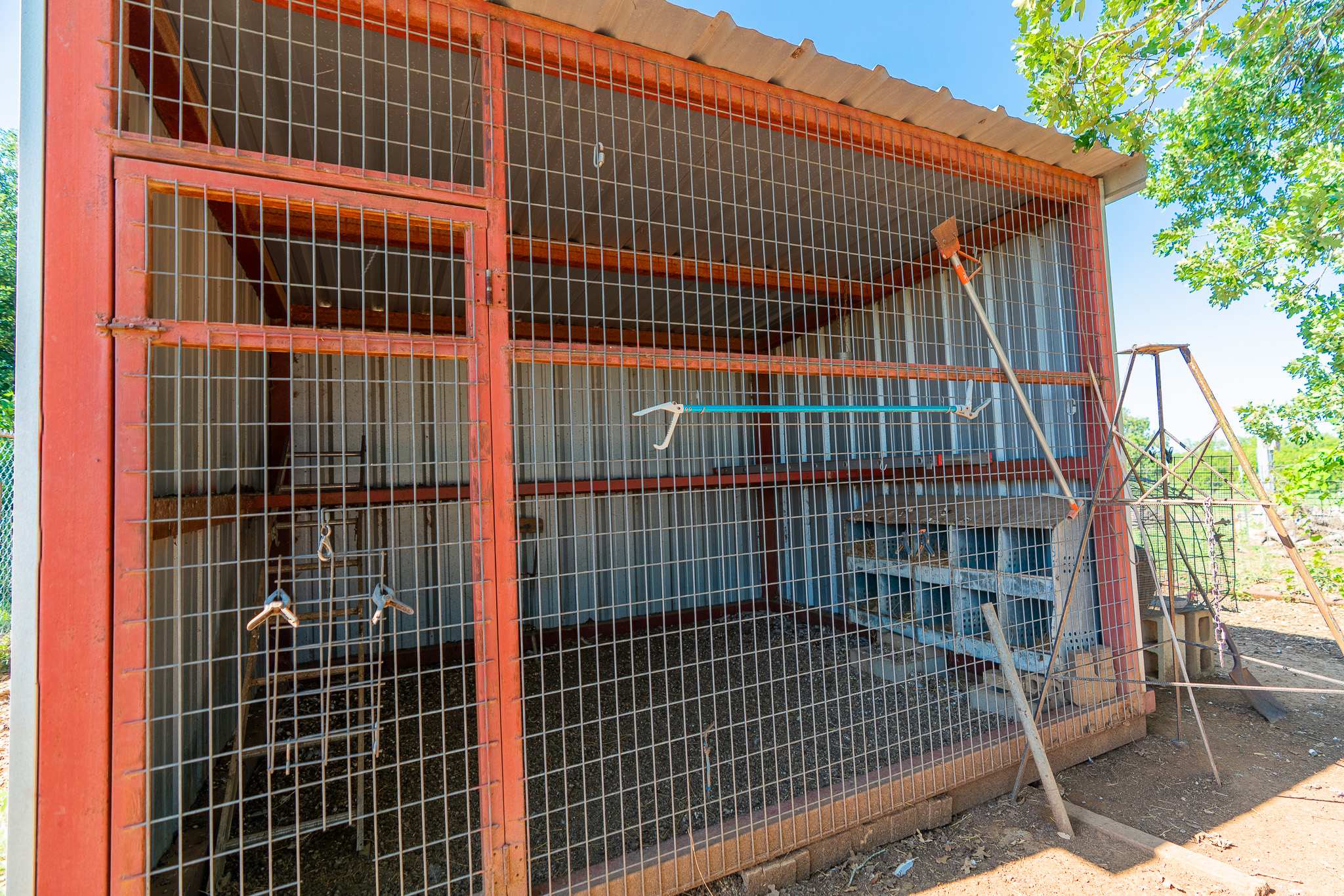 400 619th Spur Elgin, TX 78621 - Photo 34 of 40 A durable wire-mesh enclosure offers secure outdoor storage for tools and equipment.