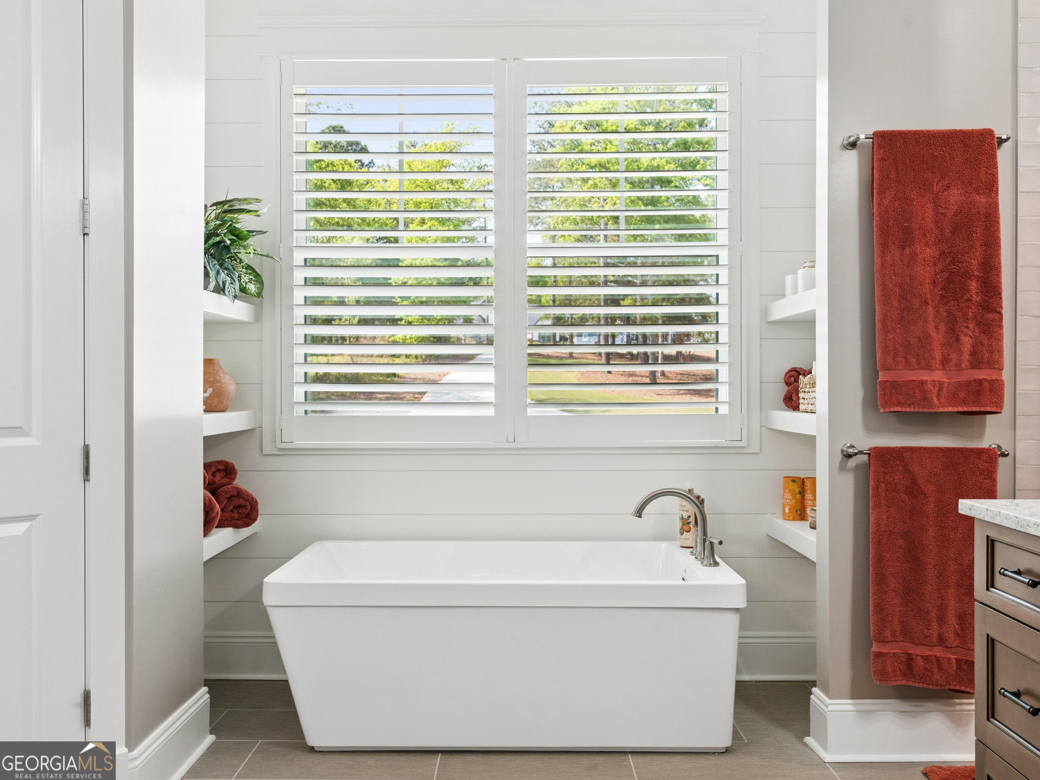 143 Carlota Way Hartwell, GA 30643 - Photo 15 of 48 a bathroom with a bathtub and a window