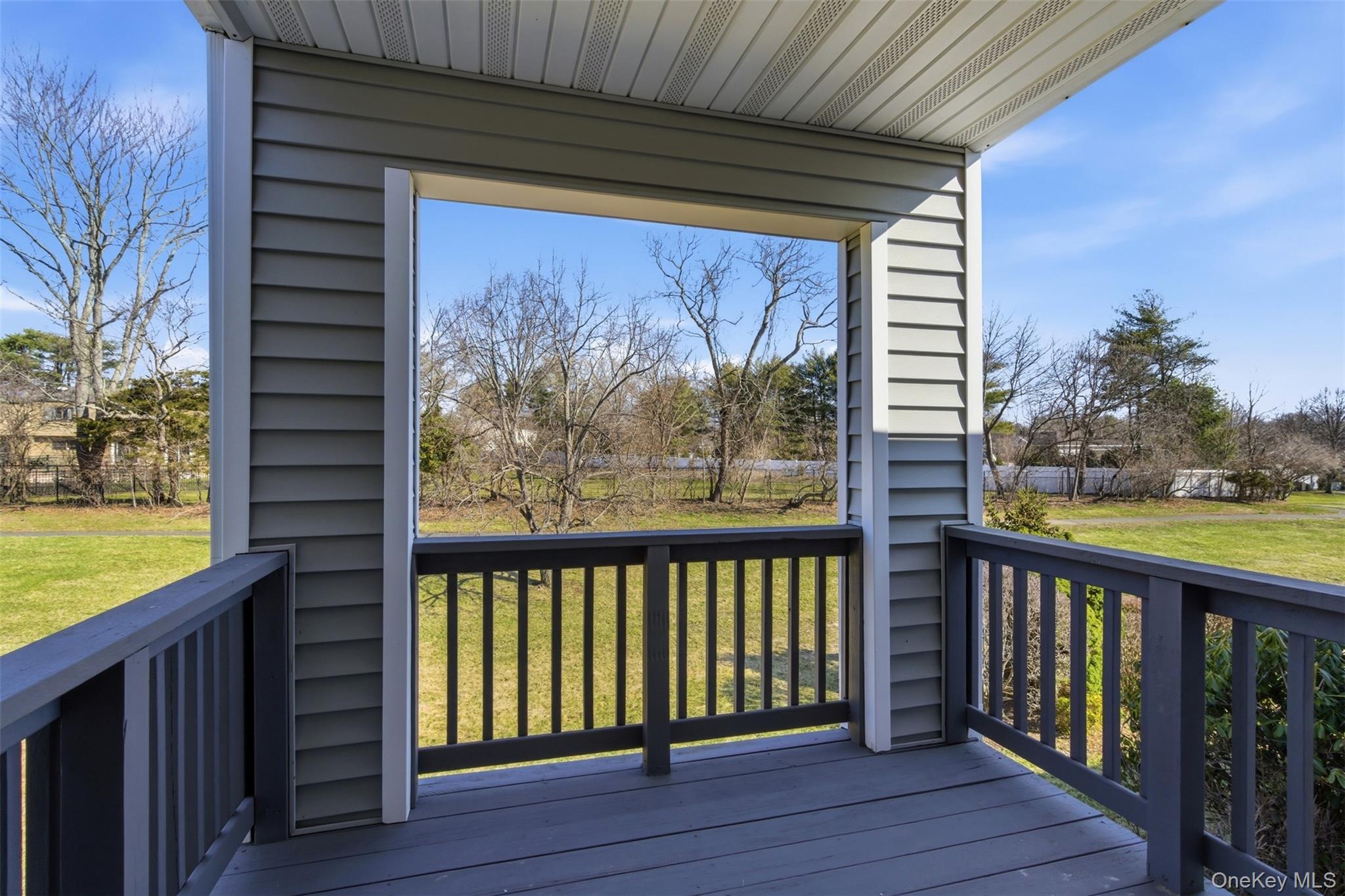 909 Fenway Road St. James, NY 11780 - Photo 27 of 34 Covered Deck With Nice Green Views