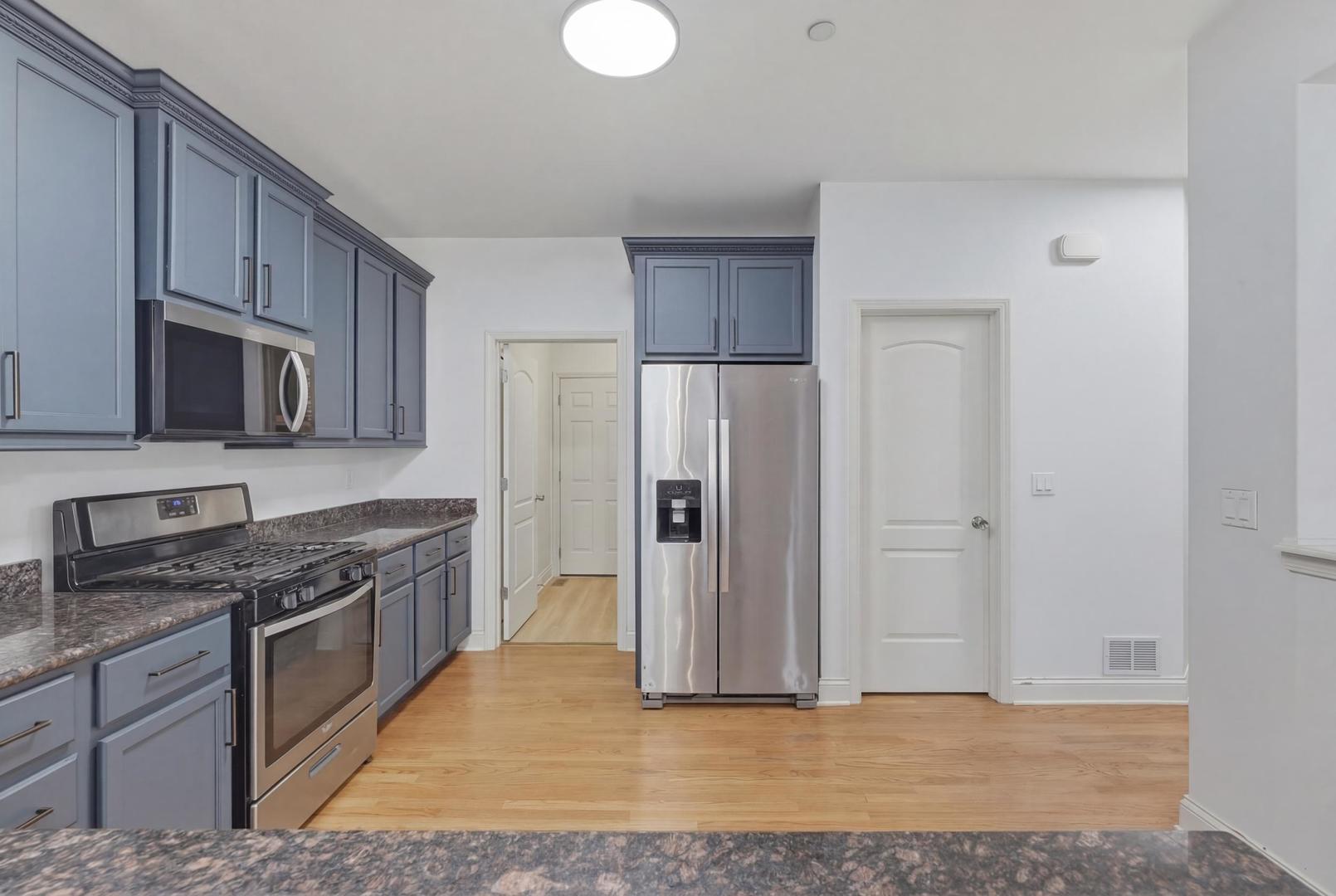 301 Nicole Way Itasca, IL 60143 - Photo 13 of 38 a kitchen with stainless steel appliances granite countertop a refrigerator stove and sink