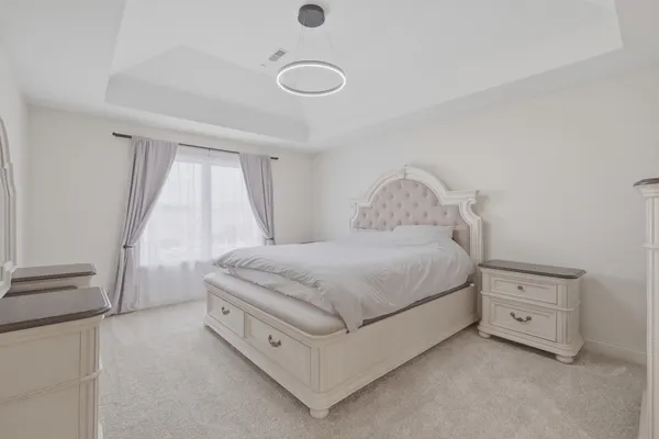 a spacious bedroom with a bed and a window