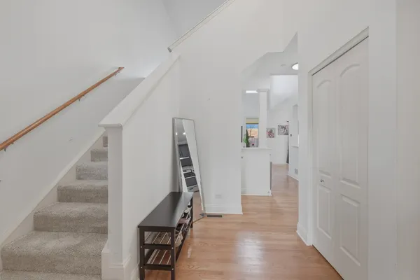 a view of entryway with furniture and wooden floor