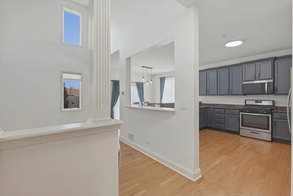 a kitchen with granite countertop a refrigerator and a stove top oven
