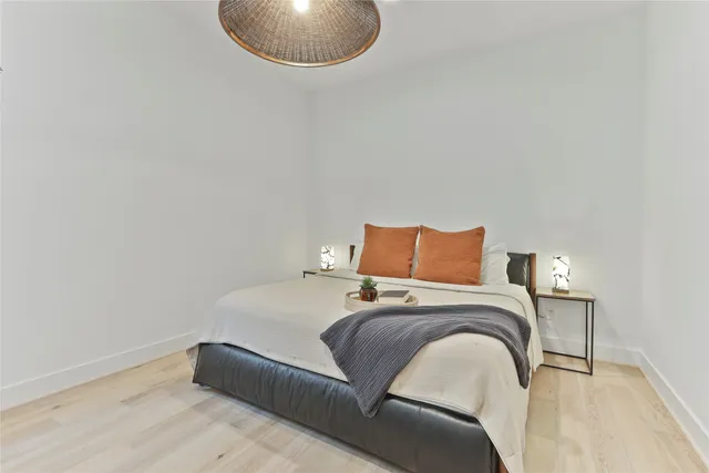 a bedroom with a bed and a white wall