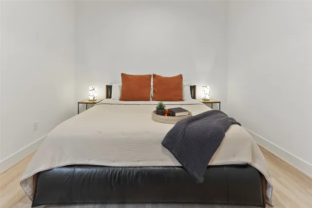 a bedroom with a bed and a night stand