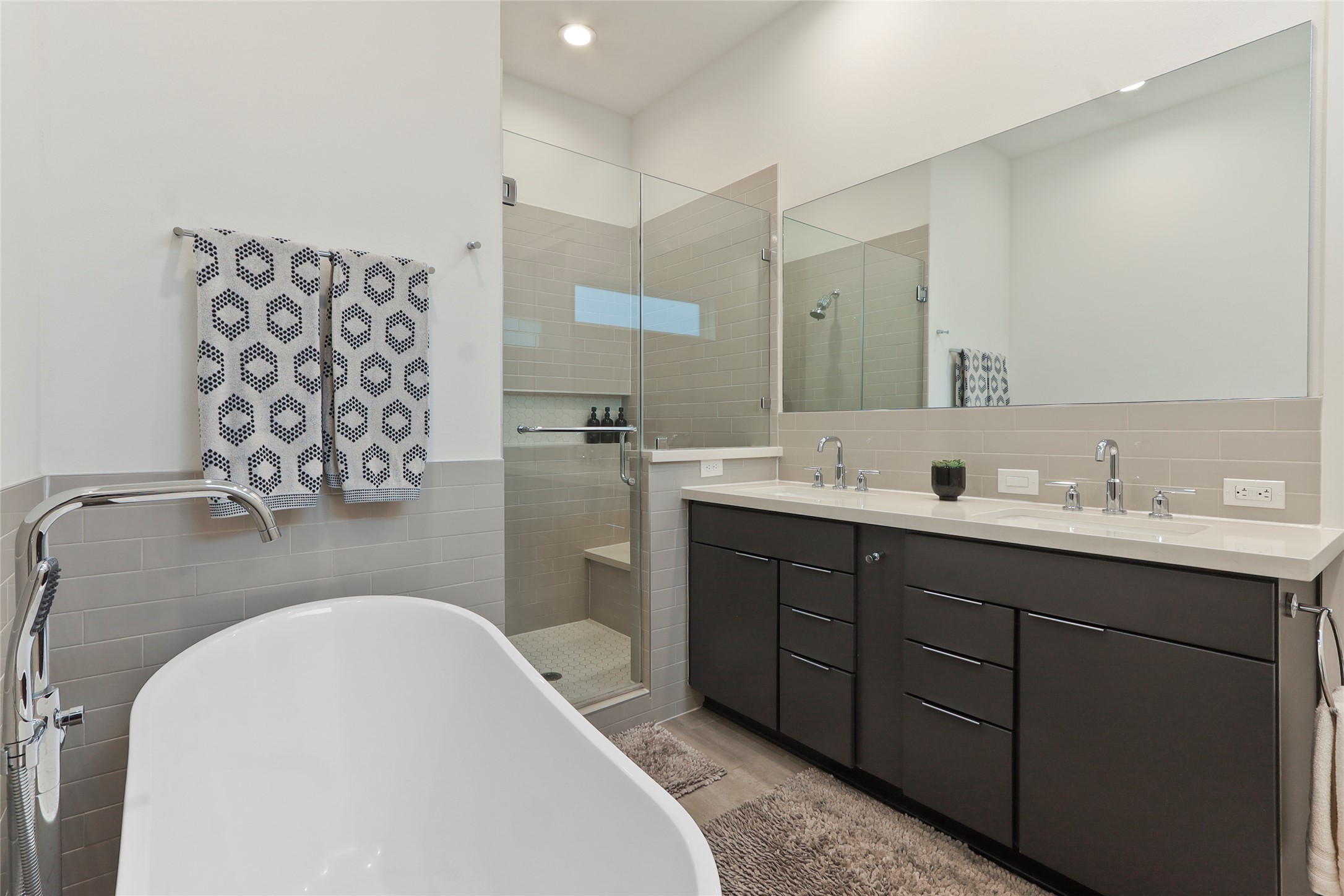 1141 West 17th Street, Unit A Houston, TX 77008 - Photo 14 of 18 Full bath with a shower featuring a sitting bench, a free standing soaking tub, double vanity, and tile walls