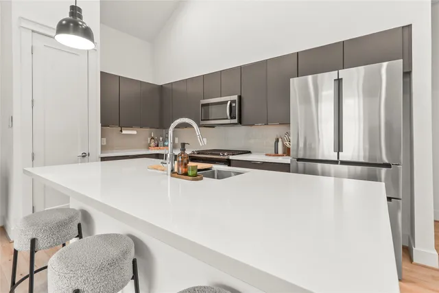 a kitchen with a refrigerator and a sink