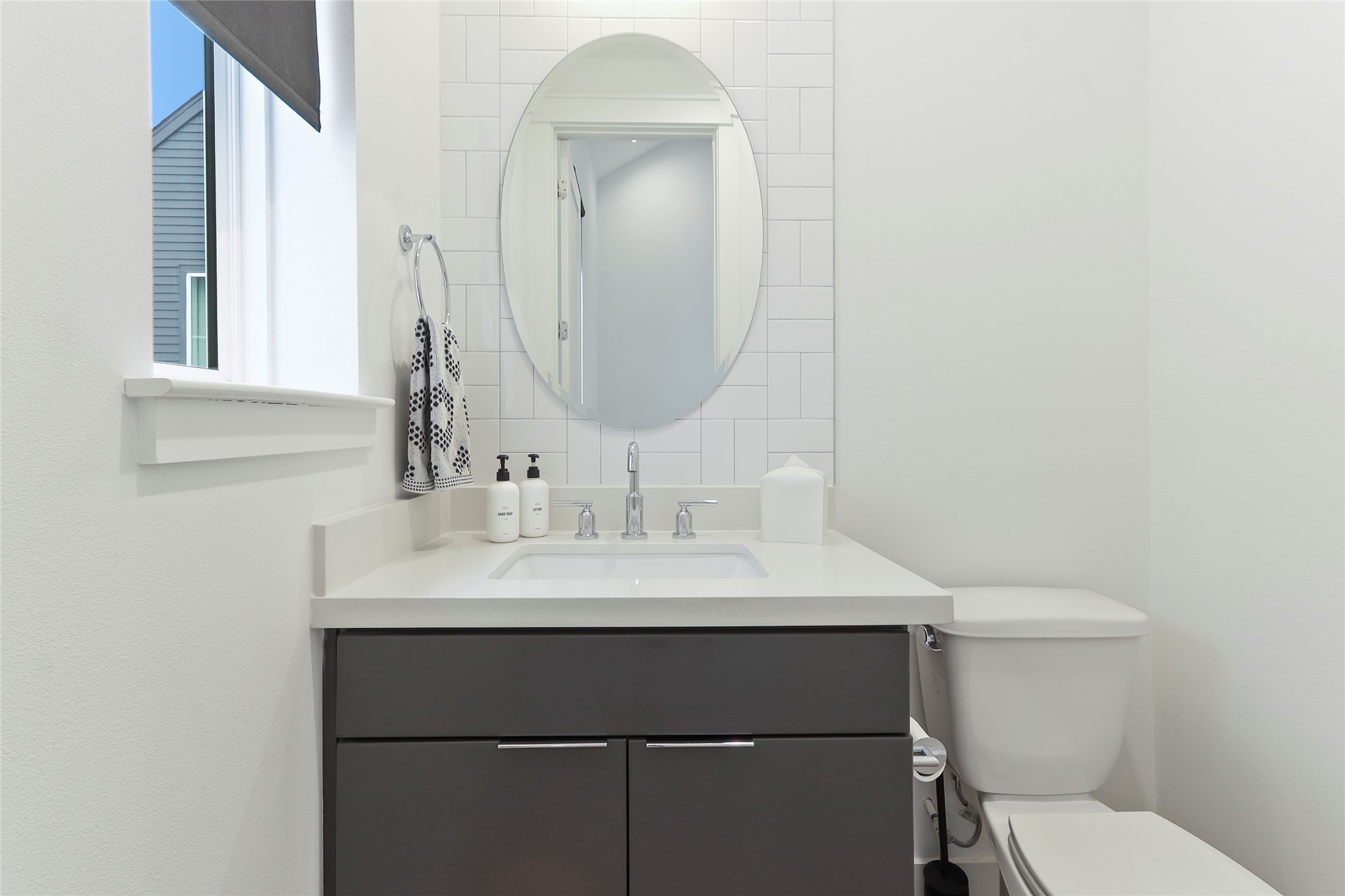 1141 West 17th Street, Unit A Houston, TX 77008 - Photo 9 of 18 Half bath featuring vanity and toilet at the top of the stair landing