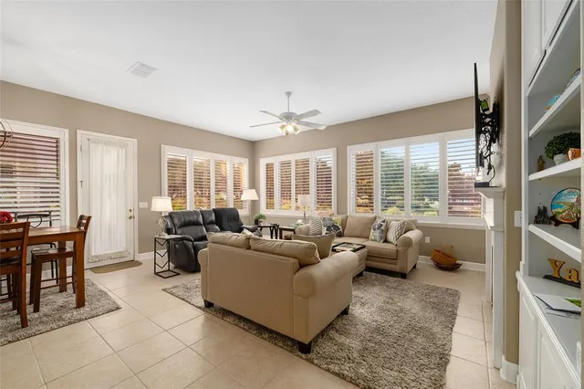 a living room with furniture and large windows