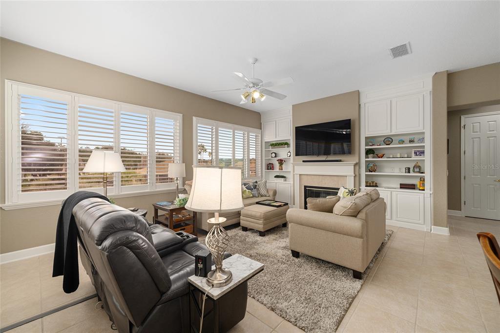 9479 Southeast 130th Street Road Summerfield, FL 34491 - Photo 12 of 67 a living room with furniture flat screen tv and a large window
