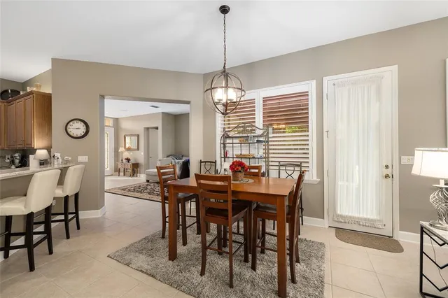 a view of a dining room and livingroom with furniture wooden floor and a chandelier